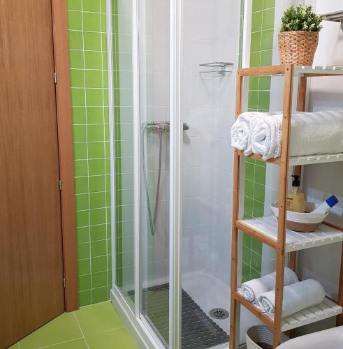 a bathroom with a shower with green tiles at ESTUDIO IDEAL 2 EN VIGO PARA VACACIONES Y TRABAJO in Vigo