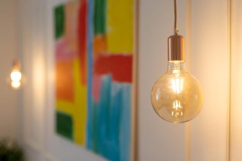 a glass light bulb hanging from a wall at Sweet rooms in Split