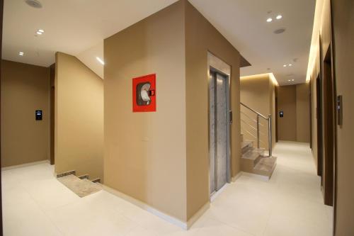 a hallway with stairs and a red picture on the wall at Duka's Hotel in Ksamil
