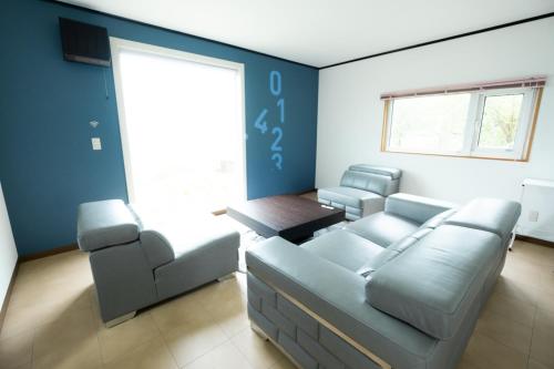 a living room with a couch and a table at Lake Toya and Nakajima in Lake Toya