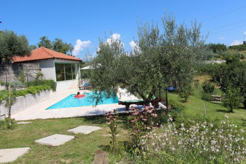 a house with a swimming pool in a garden at Zoi Apartments in Dobrovo