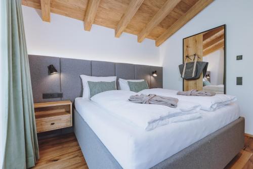 two beds in a room with a large bed at CHALET VILLAGE ZAGLGUT Wellness & Views with Summer Card Included in Kaprun
