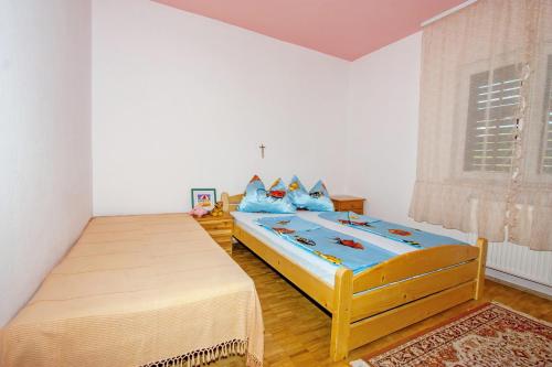 a bedroom with two twin beds and a window at Apartment Josip in Supetar