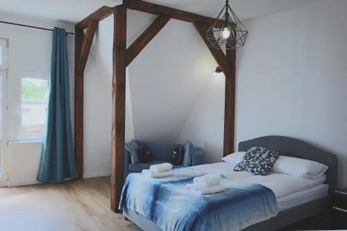 a bedroom with a bed with two towels on it at Primavera Apartments by OneApartments in Sopot