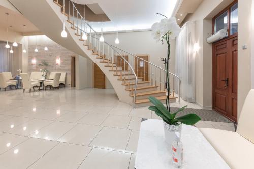 a living room with a staircase and a table and chairs at Valensija - Suite for two in nice hotel in Jūrmala