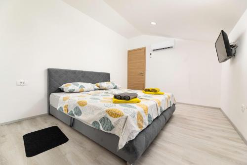a bedroom with a bed in a white room at Villa Veroniq in Županje