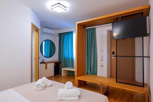 a hotel room with a bed and a tv at Royal 1967 in Himare