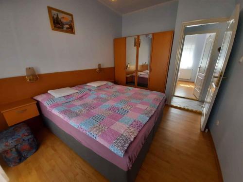 シオーフォクにあるApartment Siofok, Lake Balaton 6のベッドルーム1室(ピンクとブルーのキルトのベッド1台付)