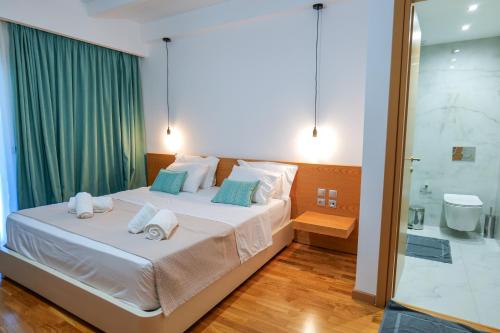 a bedroom with a large bed and a shower at Royal 1967 in Himare