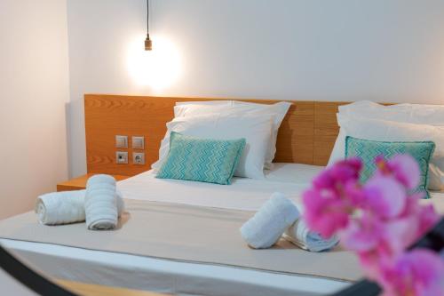 a bedroom with a bed with towels on it at Royal 1967 in Himare