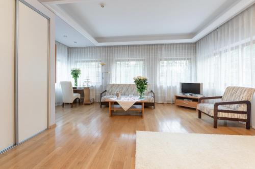 a living room with a couch and a table at Valensija - Large Suite apartment in Jūrmala