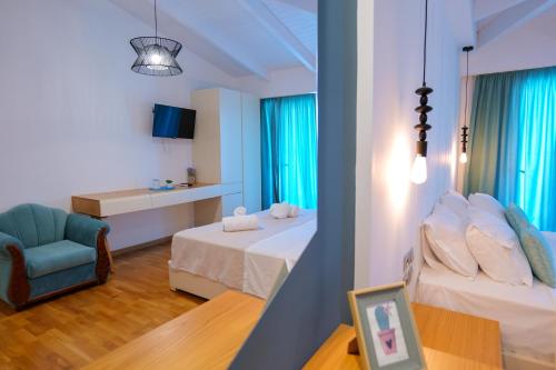 a hotel room with two beds and a chair at Royal 1967 in Himare