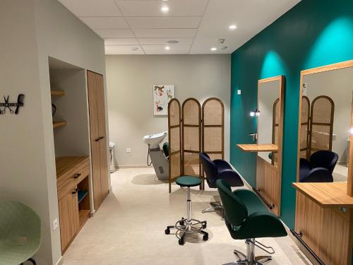 a salon with green walls and chairs in a room at DOMITYS L'HOROLOGIA in Cluses