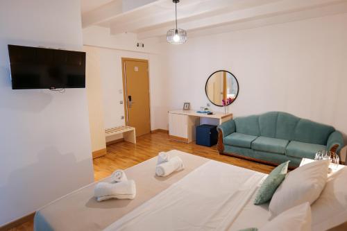a living room with a bed and a green couch at Royal 1967 in Himare