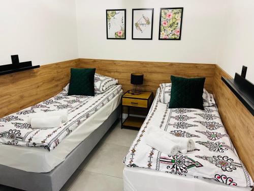 two beds sitting next to each other in a room at WRZOS resort & wellness **** DOMKI CAŁOROCZNE in Węgierska Górka