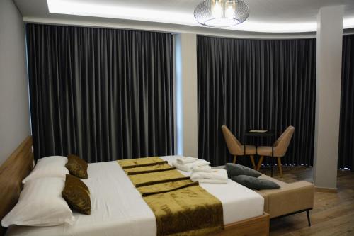 En eller flere senge i et værelse på HOTEL BRAXTON