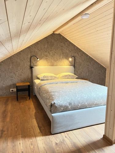 a bedroom with a bed in a attic at Kuršių Take in Šventoji