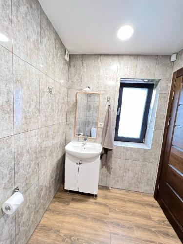 a bathroom with a sink and a mirror at Kuršių Take in Šventoji