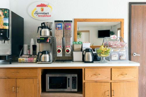 a kitchen with a counter top with a microwave at Super 8 by Wyndham Twinsburg/Cleveland Area in Twinsburg