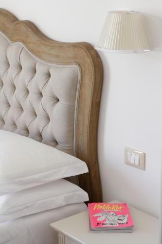 a bed with a lamp and a book on a table at Agriturismo Emidio Pepe in Torano Nuovo