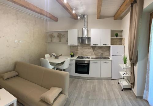 a kitchen and living room with a couch and a table at La Casetta di Anna, Terni in Terni