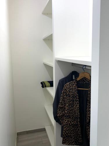 a closet with a shelf with a leopard shirt at La Casetta di Anna, Terni in Terni
