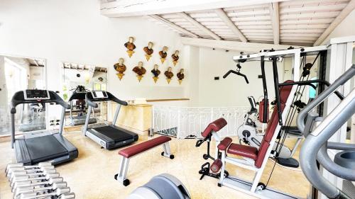 a gym with treadmills and cardio machines at Byblos Art Hotel Villa Amistà in San Pietro in Cariano