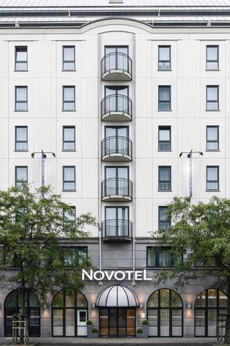 a white building with a novation sign on it at Novotel Brussels Centre Midi in Brussels