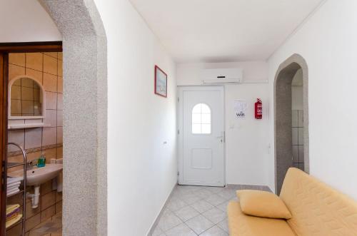 a living room with a couch and a sink at Apartments Albina in Lopar