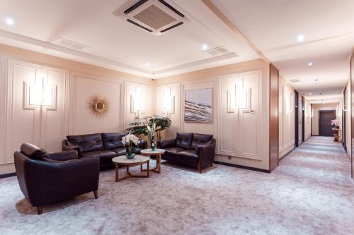 a living room with couches and a table at HUSMA Hotel & Spa in Tashkent
