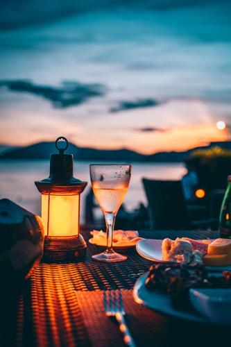 a table topped with a glass of wine and a candle at Mandarin Oriental, Sanya in Sanya