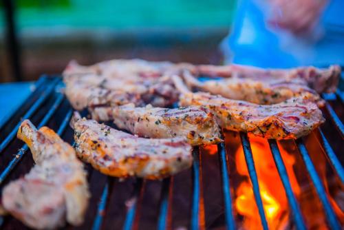 a group of meat being cooked on a grill at Mandarin Oriental, Sanya in Sanya
