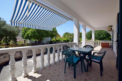 a balcony with a table and chairs on a balcony at House Sun and Sea in Olib