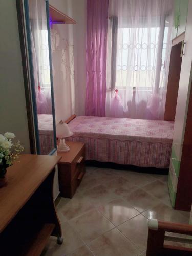 a small bedroom with a bed and a mirror at Casa a Gallipoli a 1 minuto dal mare in Gallipoli