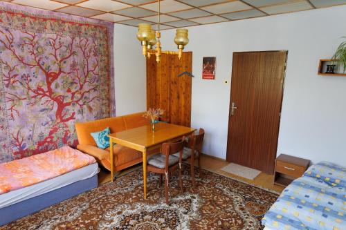a living room with a table and a couch at Tatry Liptov in Jakubovany