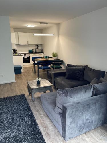 a living room with a couch and a table at Luxus Apartament in Ammersbek