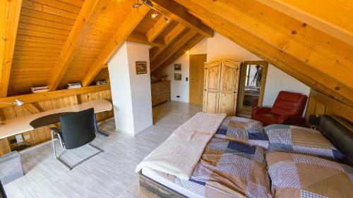 a bedroom with a large bed in a attic at Appartement Lena in Weissach Im Tal
