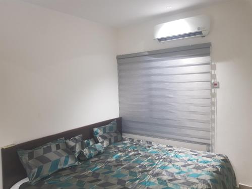 a bedroom with a bed in a room at SBJ Place East Legon in Accra