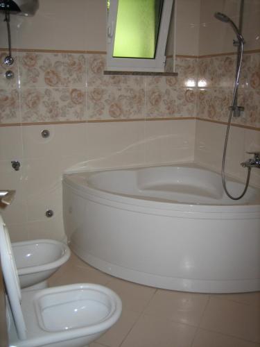 a bathroom with a tub and a toilet at Apartma Janja in Portorož