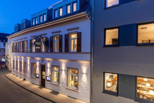 a white building with many windows on a street at BC Hotel Bad Kreuznach mit Restaurant Mühlentor in Bad Kreuznach