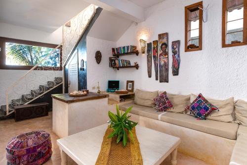 a living room with a couch and a staircase at Villa Lala in Kiwengwa