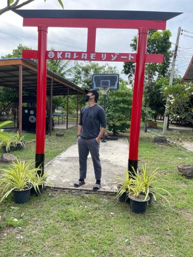 a man standing in front of a red structure at Kalae Resort in Ban Nong Ben