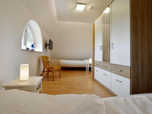 a bedroom with a bed and a dresser with a mirror at Villa Fasan in Trent