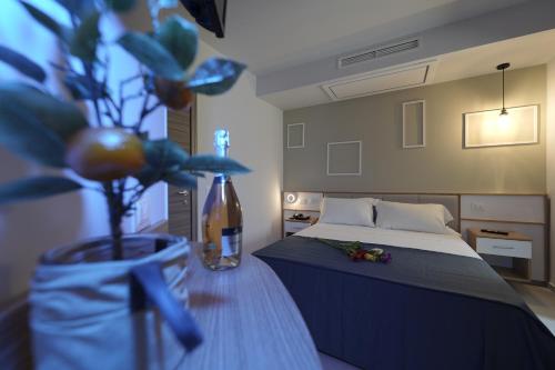 a bedroom with a bed and a vase with a plant at ELISEO PALACE TROPEA in Tropea