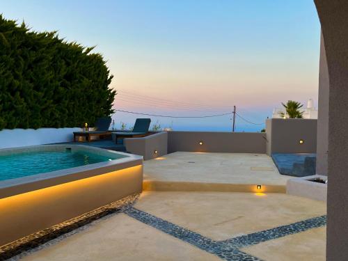 a swimming pool on a patio with a view of the ocean at Elements Cozy Suites Pyrgos in Pirgos