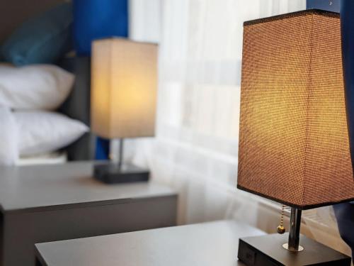a lamp sitting on a table in a bedroom at No Five - Worthing in Worthing