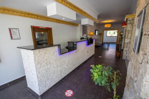 a lobby with a counter with purple stairs at TURUNÇ DREAM HOTEL in Mugla