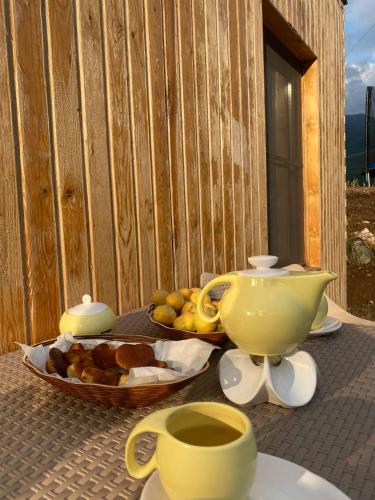 a table with a tea pot and a bowl of fruit at Tevra Hotel, Top of the Mountain, Camping, Nature, Ijevan, Dilijan in Ijevan