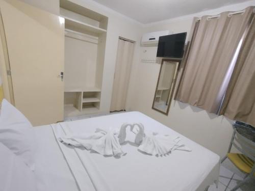 Ένα ή περισσότερα κρεβάτια σε δωμάτιο στο Pousada Aconchego