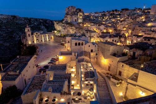 an aerial view of a city at night at PIANELLE RESORT in Matera